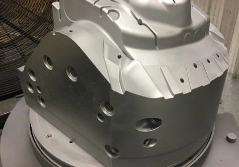 Metal workpiece with bores and contours